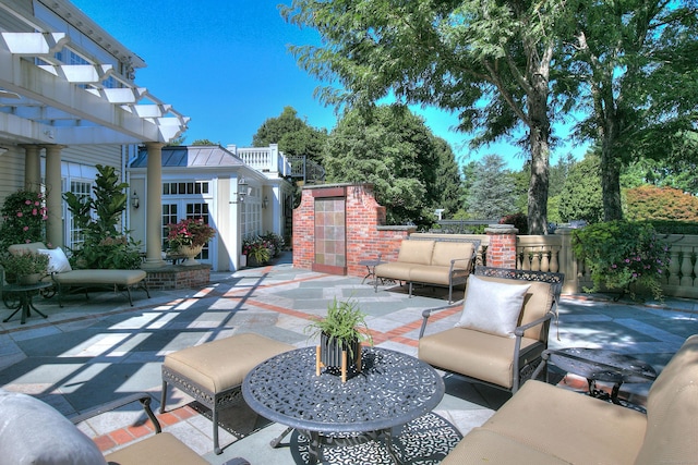 view of patio / terrace featuring a pergola and an outbuilding