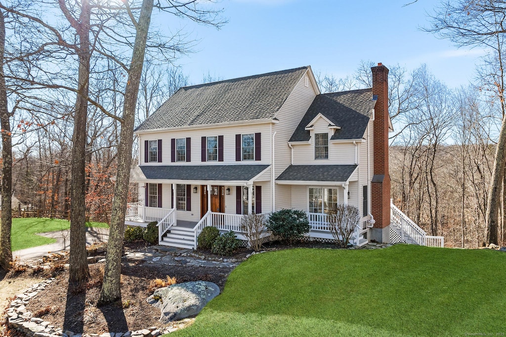 view of front of house with a front lawn and a porch