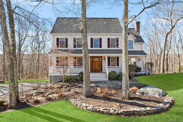 colonial-style house with a front yard and a porch