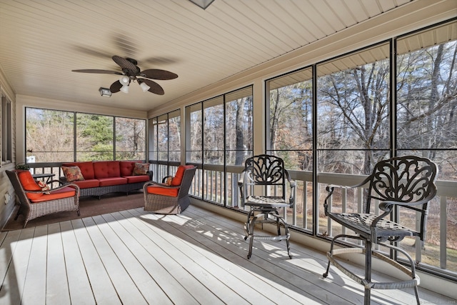 sunroom / solarium featuring ceiling fan