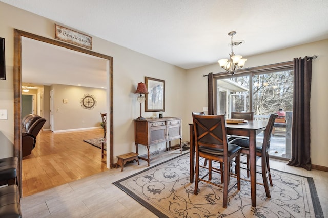 dining room with a chandelier and light hardwood / wood-style flooring