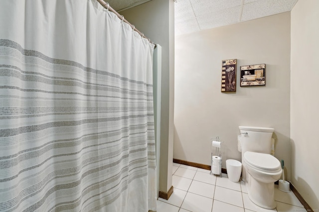 bathroom with toilet, a shower with shower curtain, and tile patterned floors