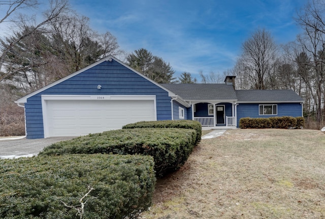 ranch-style home featuring a front lawn, a porch, and a garage