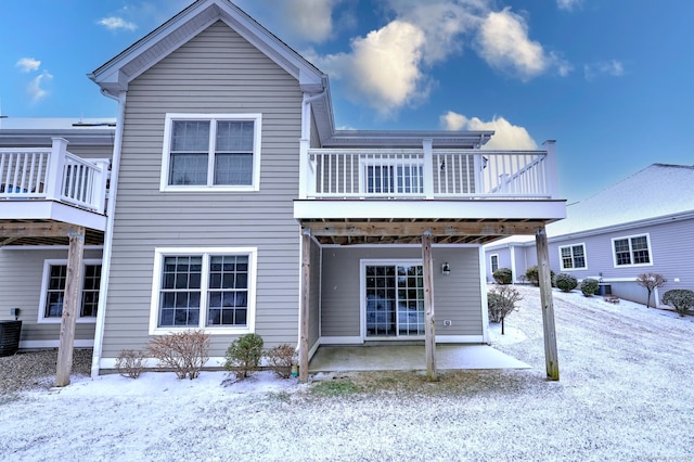 view of snow covered back of property