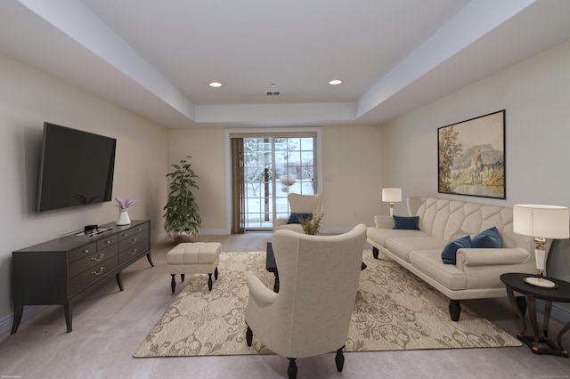 living room featuring a raised ceiling