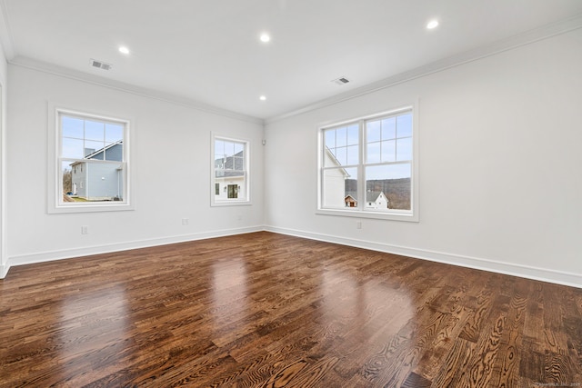 spare room with dark wood-type flooring and ornamental molding