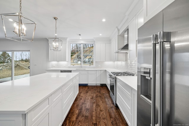 kitchen with pendant lighting, white cabinetry, and high end appliances