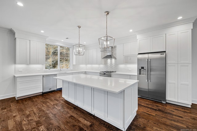 kitchen with premium appliances, a kitchen island, dark hardwood / wood-style flooring, and white cabinetry