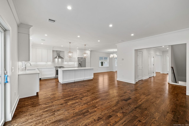 unfurnished living room with dark hardwood / wood-style floors, sink, and crown molding