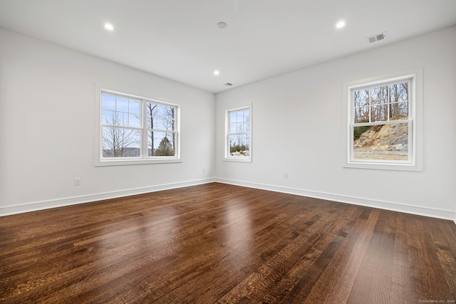 spare room featuring dark hardwood / wood-style flooring