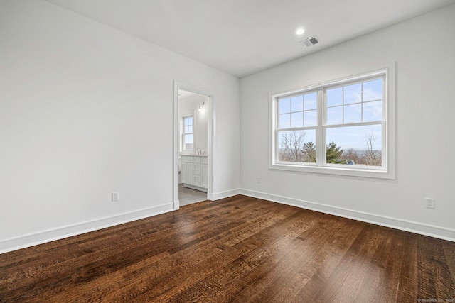 spare room featuring wood-type flooring