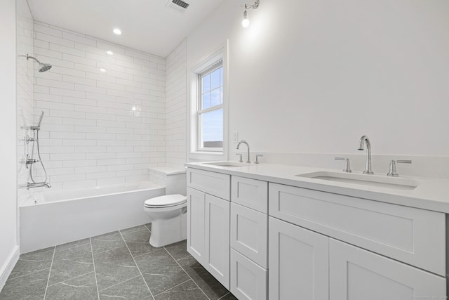 full bathroom featuring vanity, toilet, and tiled shower / bath