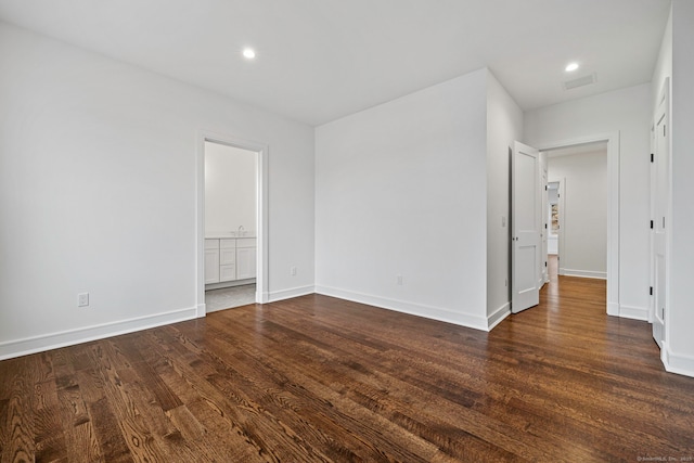 spare room featuring dark hardwood / wood-style flooring