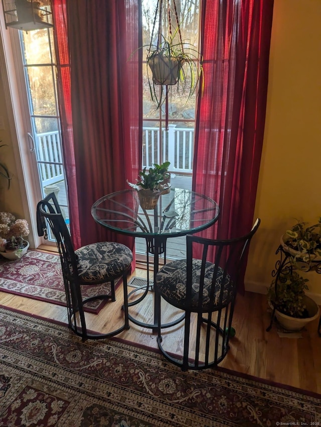 dining space with wood finished floors