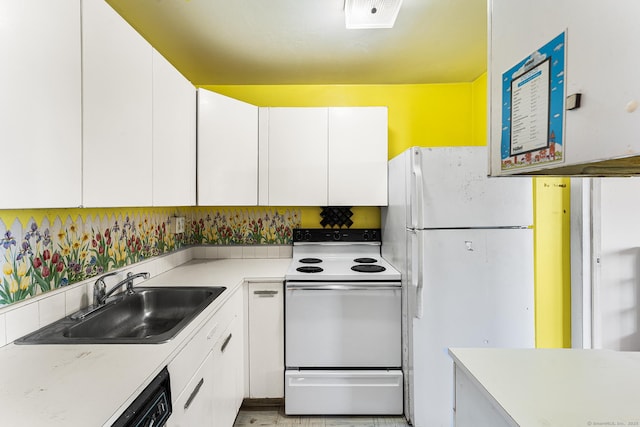 kitchen featuring sink, white cabinets, and white appliances