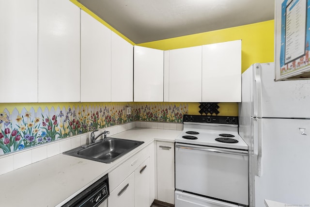 kitchen with white appliances, white cabinetry, and sink