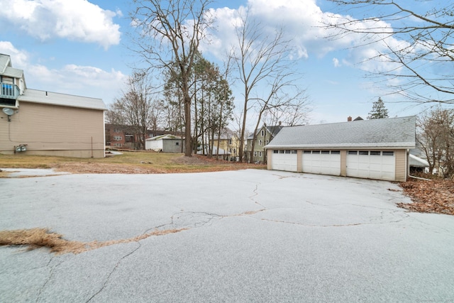 view of yard featuring a garage, a shed, and an outdoor structure