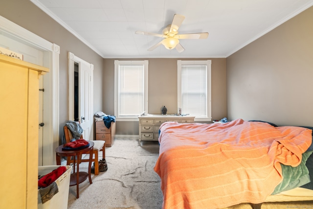 bedroom with carpet, ceiling fan, and crown molding