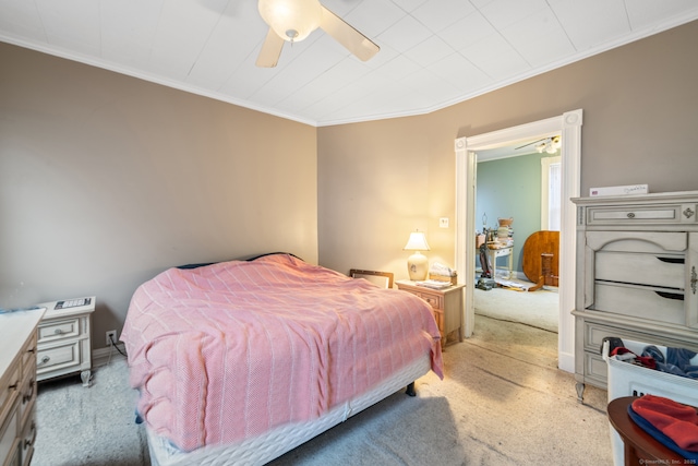 bedroom with light carpet, ceiling fan, and crown molding