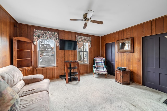 interior space with a ceiling fan and light carpet