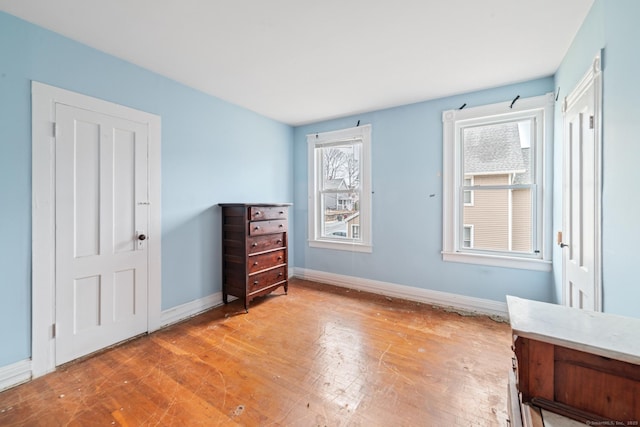 unfurnished bedroom with light wood-style floors and baseboards