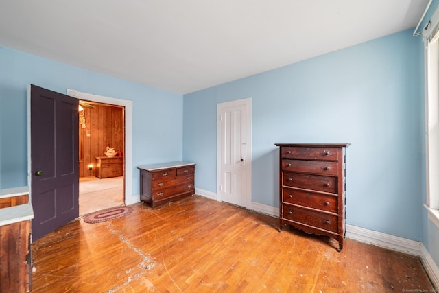 unfurnished bedroom featuring light wood-style flooring and baseboards