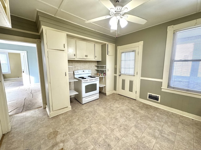 kitchen featuring baseboards, visible vents, a wainscoted wall, ceiling fan, and white electric range