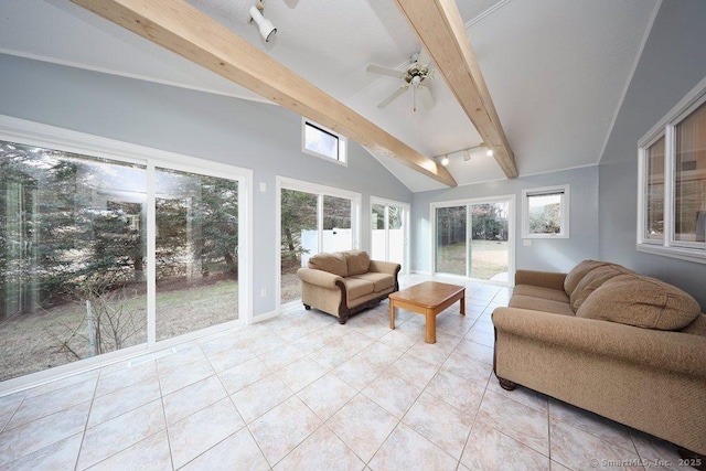 sunroom / solarium featuring track lighting, vaulted ceiling with beams, and ceiling fan