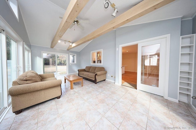 living area with track lighting, baseboards, lofted ceiling with beams, light tile patterned floors, and french doors