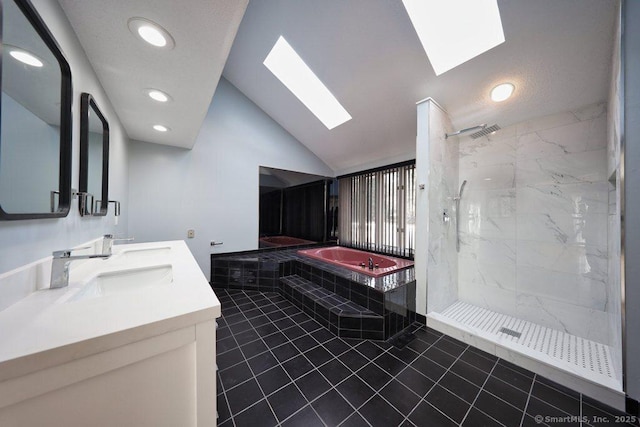 bathroom featuring tile patterned floors, vanity, lofted ceiling with skylight, and independent shower and bath