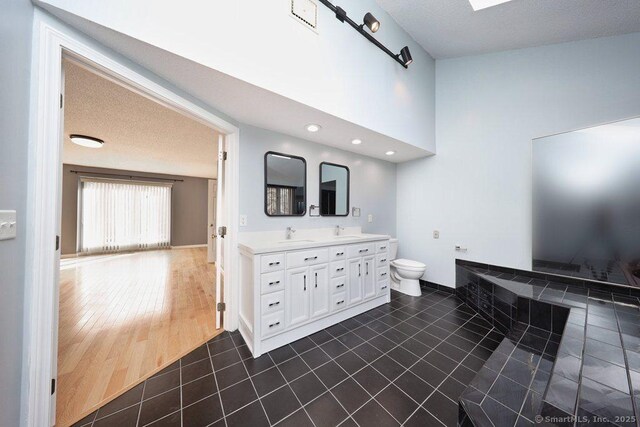 bathroom with tile patterned flooring, vanity, and toilet