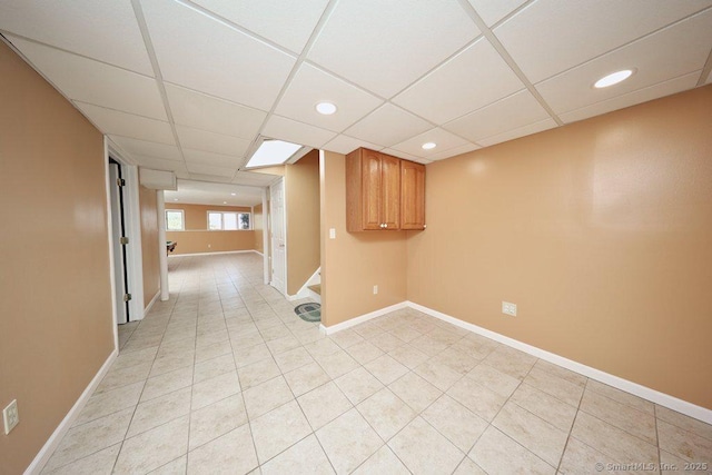 spare room with recessed lighting, baseboards, a paneled ceiling, and stairs