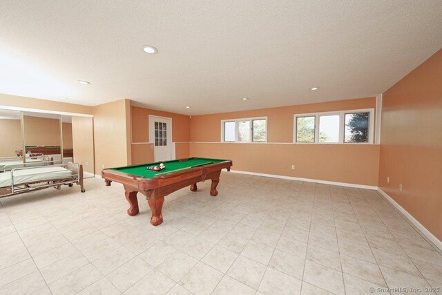 recreation room with a textured ceiling and billiards