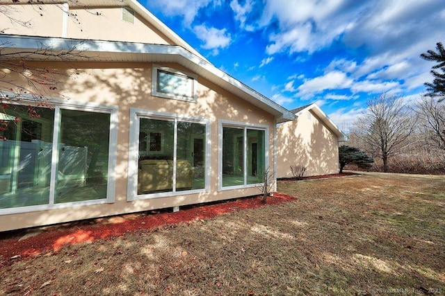 view of side of home with stucco siding