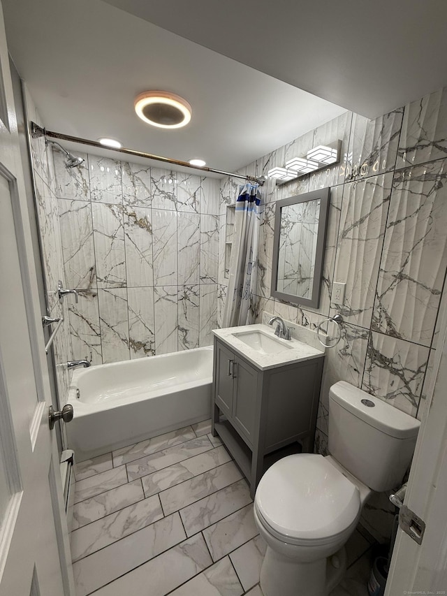 full bathroom with vanity, toilet, tile walls, and shower / bath combo with shower curtain