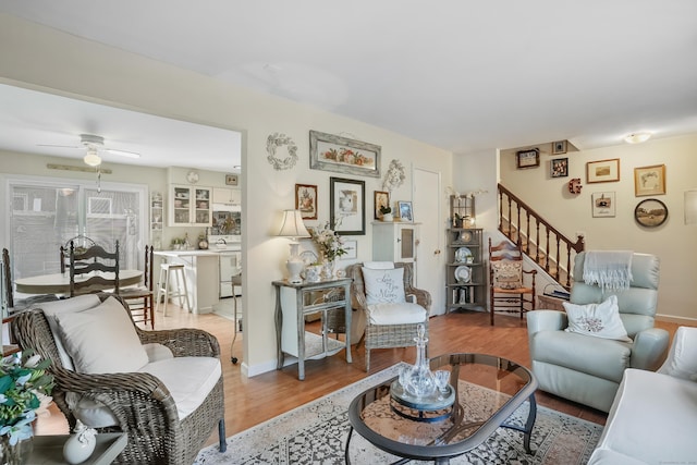 living room featuring hardwood / wood-style flooring and ceiling fan