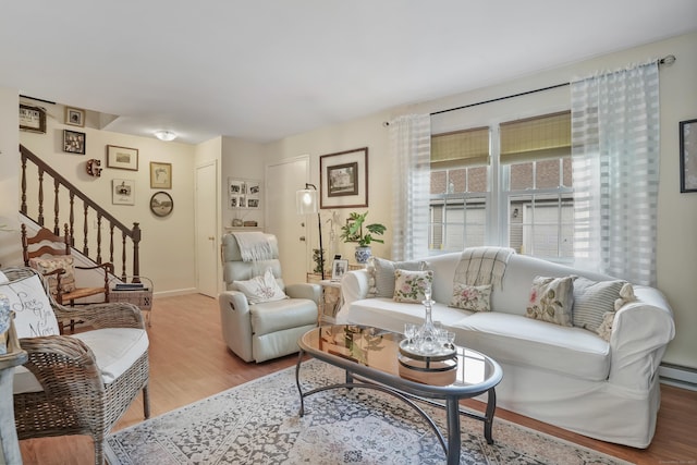 living room with light hardwood / wood-style floors and baseboard heating