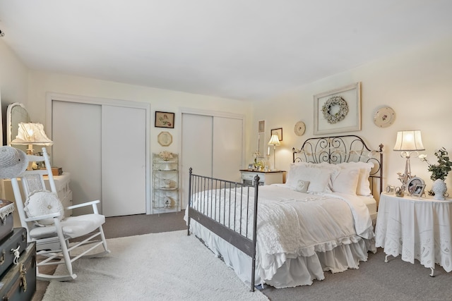 carpeted bedroom featuring two closets