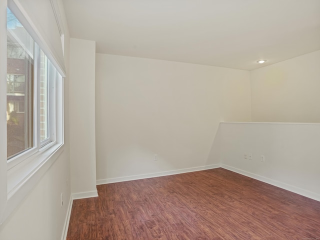 spare room featuring dark wood-type flooring