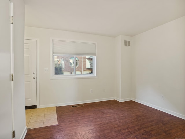 empty room with hardwood / wood-style floors