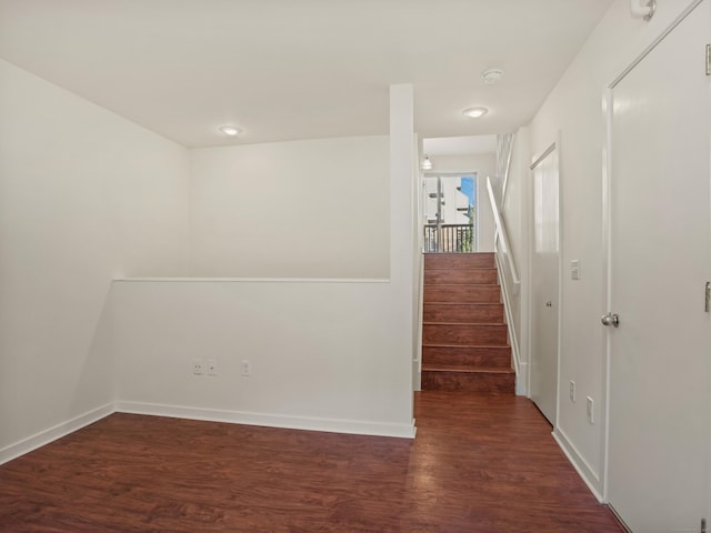 spare room with dark wood-type flooring