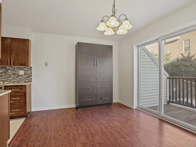 interior space with dark hardwood / wood-style flooring and an inviting chandelier