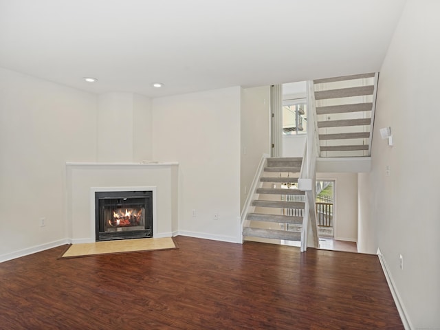 unfurnished living room featuring hardwood / wood-style floors and a wealth of natural light