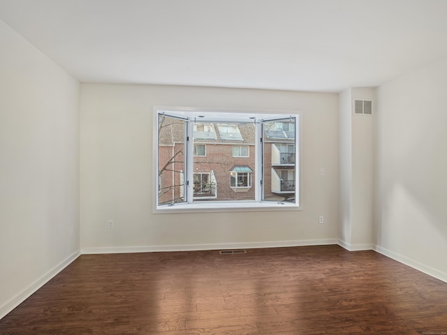 unfurnished room with dark hardwood / wood-style floors