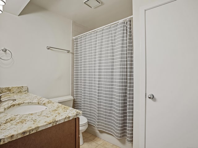 full bathroom featuring tile patterned floors, vanity, toilet, and shower / bath combo with shower curtain