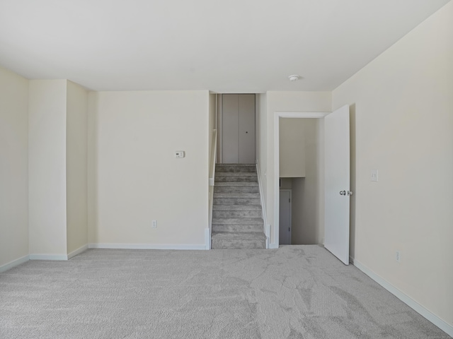 unfurnished room featuring light carpet