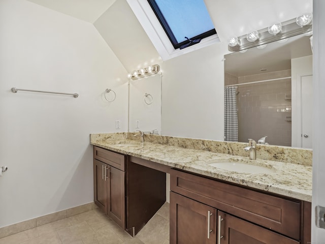 bathroom with a shower with shower curtain, vanity, tile patterned floors, and a skylight