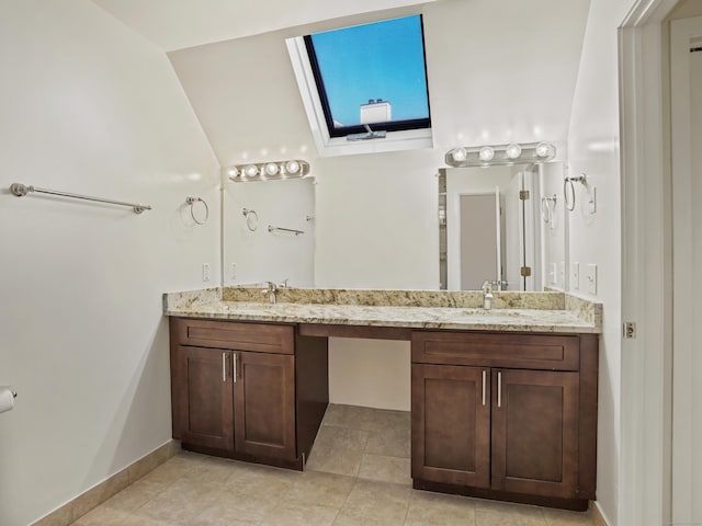 bathroom with tile patterned flooring, vanity, and lofted ceiling