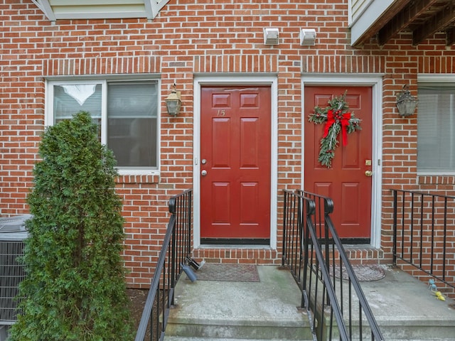 view of exterior entry featuring central AC unit