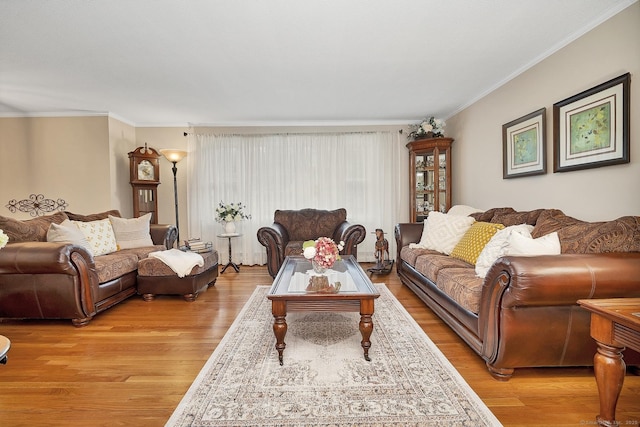 living room featuring light wood-type flooring and ornamental molding